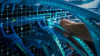 A man plugging in cables to a network switch